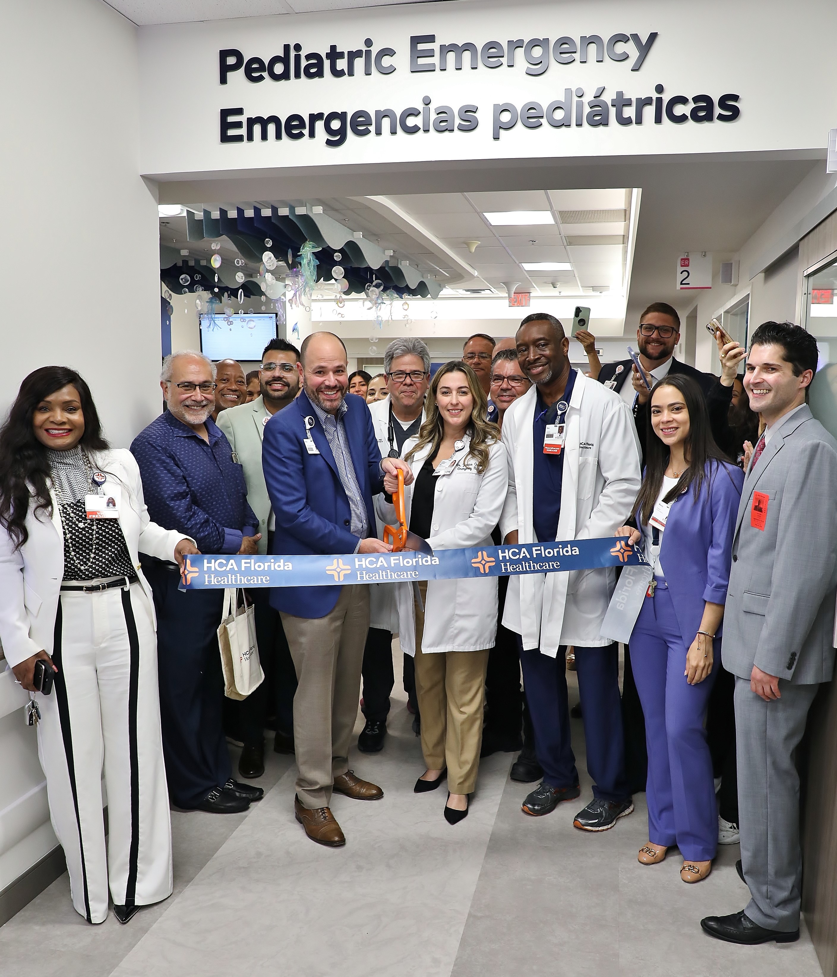 Kendall Hospital team members cutting opening day ribbon of  new Pediatric Emergency Care.