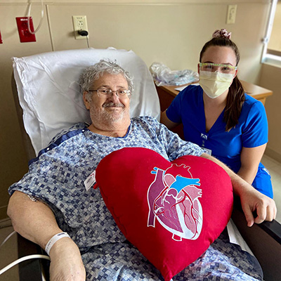 Thomas, with a nurse, after his open heart surgery