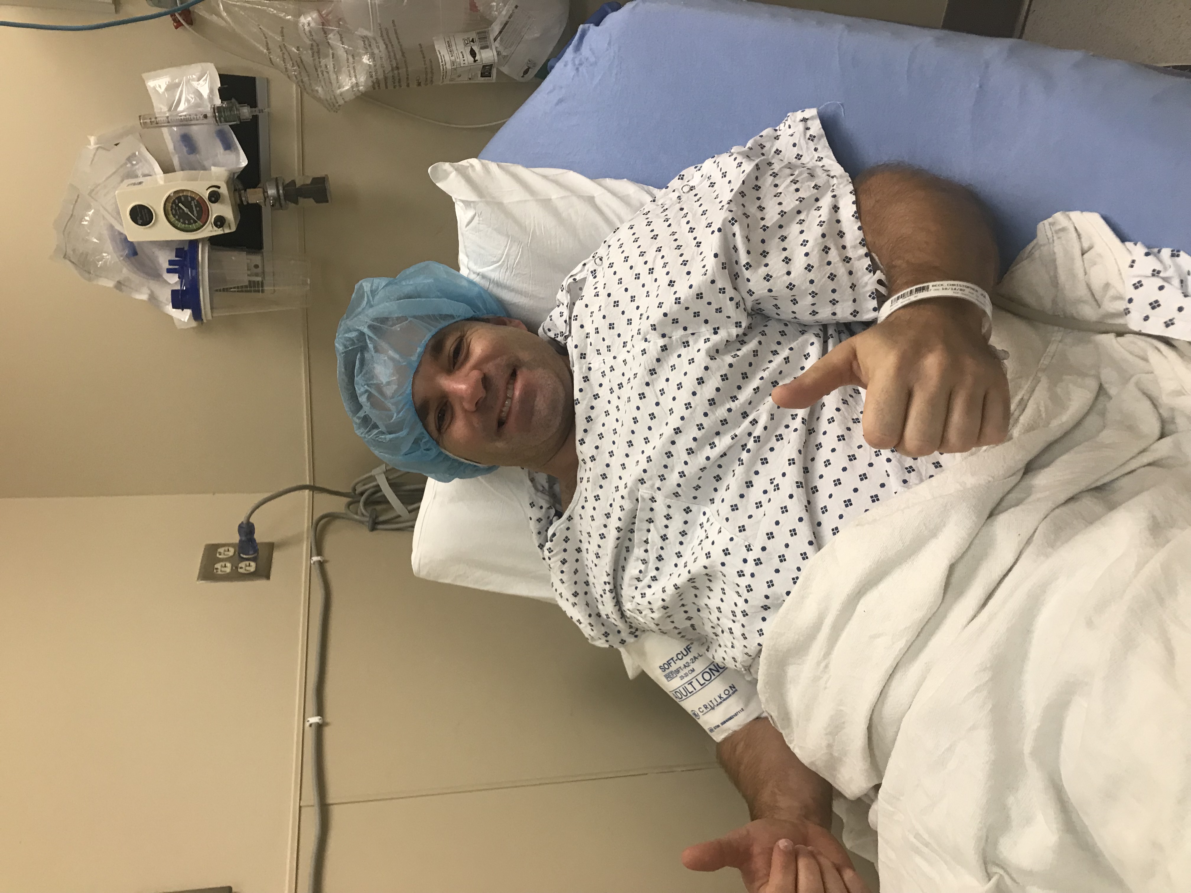 Chris Beck giving thumbs up as he prepares to enter surgery.