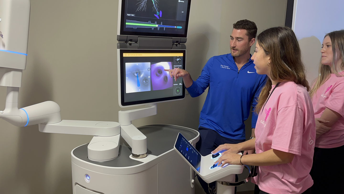 Students from Lakewood Ranch High School practice using the ION surgical robot.