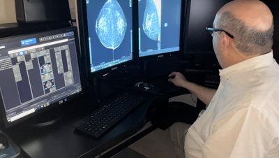 Man looking at CAT Scan image of a brain.