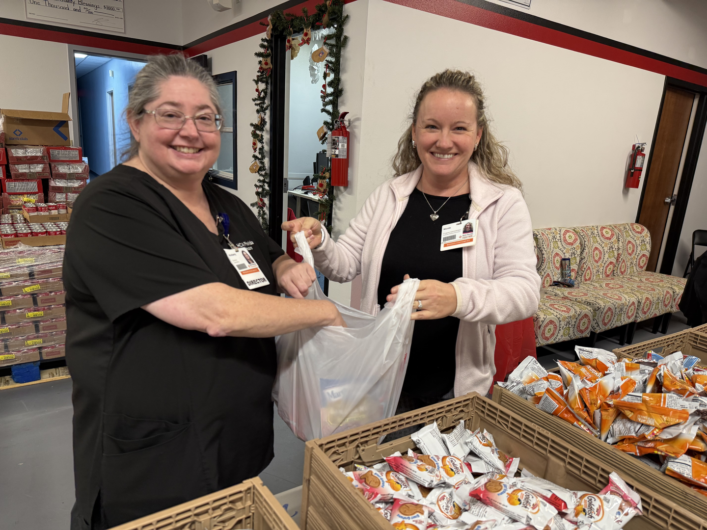 Two volunteers at the event preparing items.