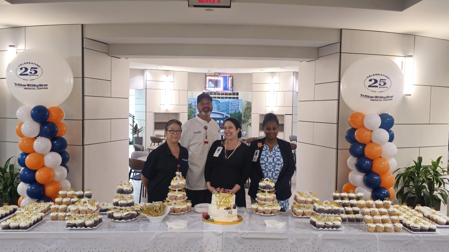 Team celebrating the 25th anniversary with treats.