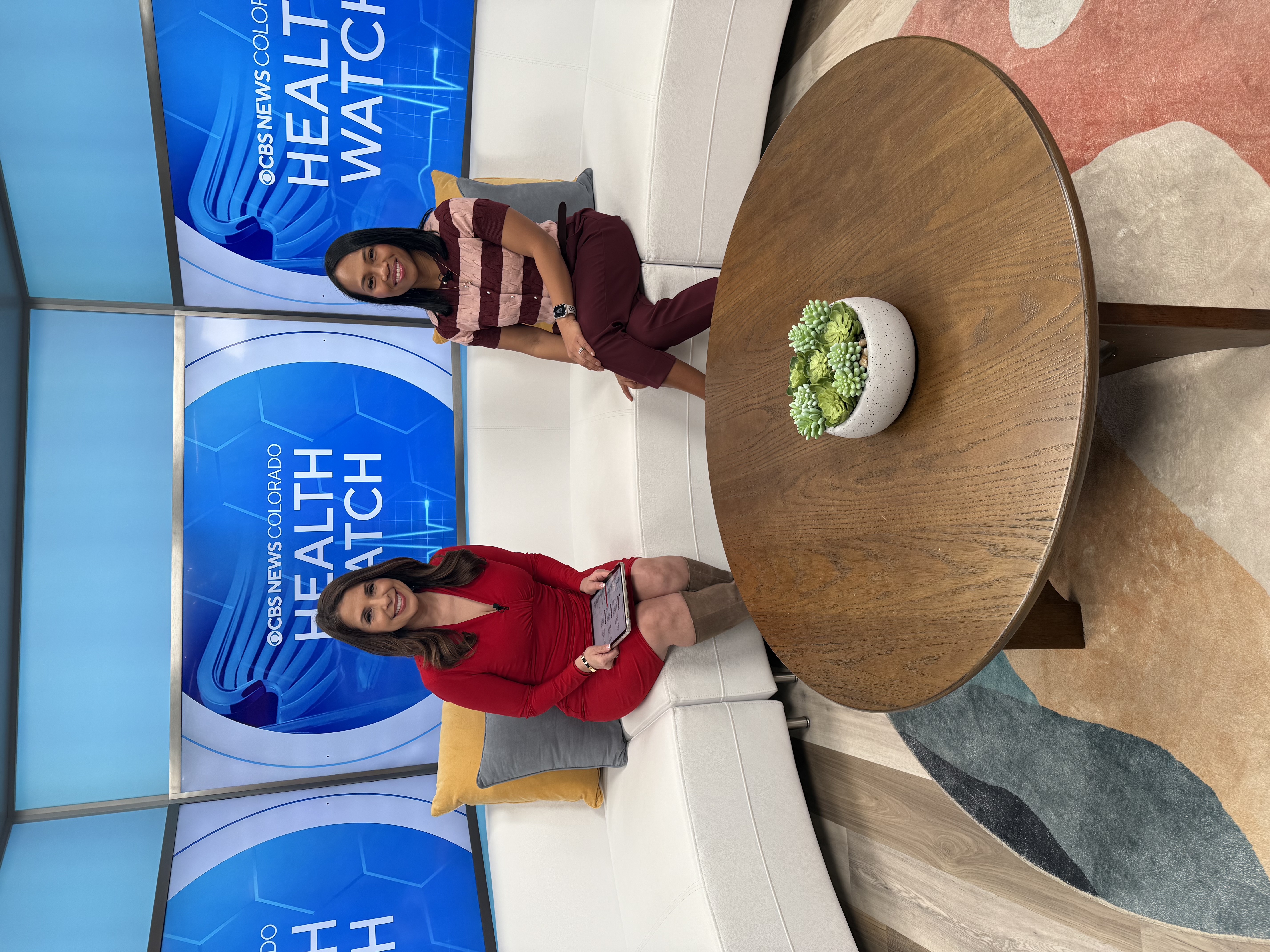 Dr Pitts and CBS News Colorado host smiling for a photo.