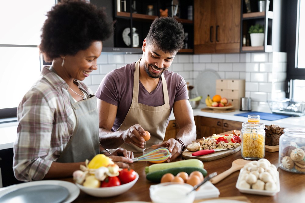 A happy couple cooking dinner together.