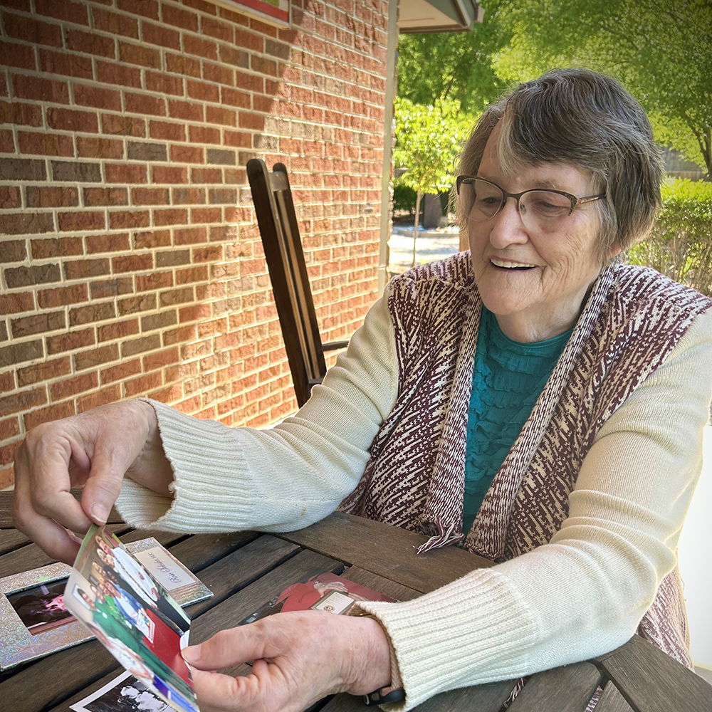 Rose happily looking through photos from her life.