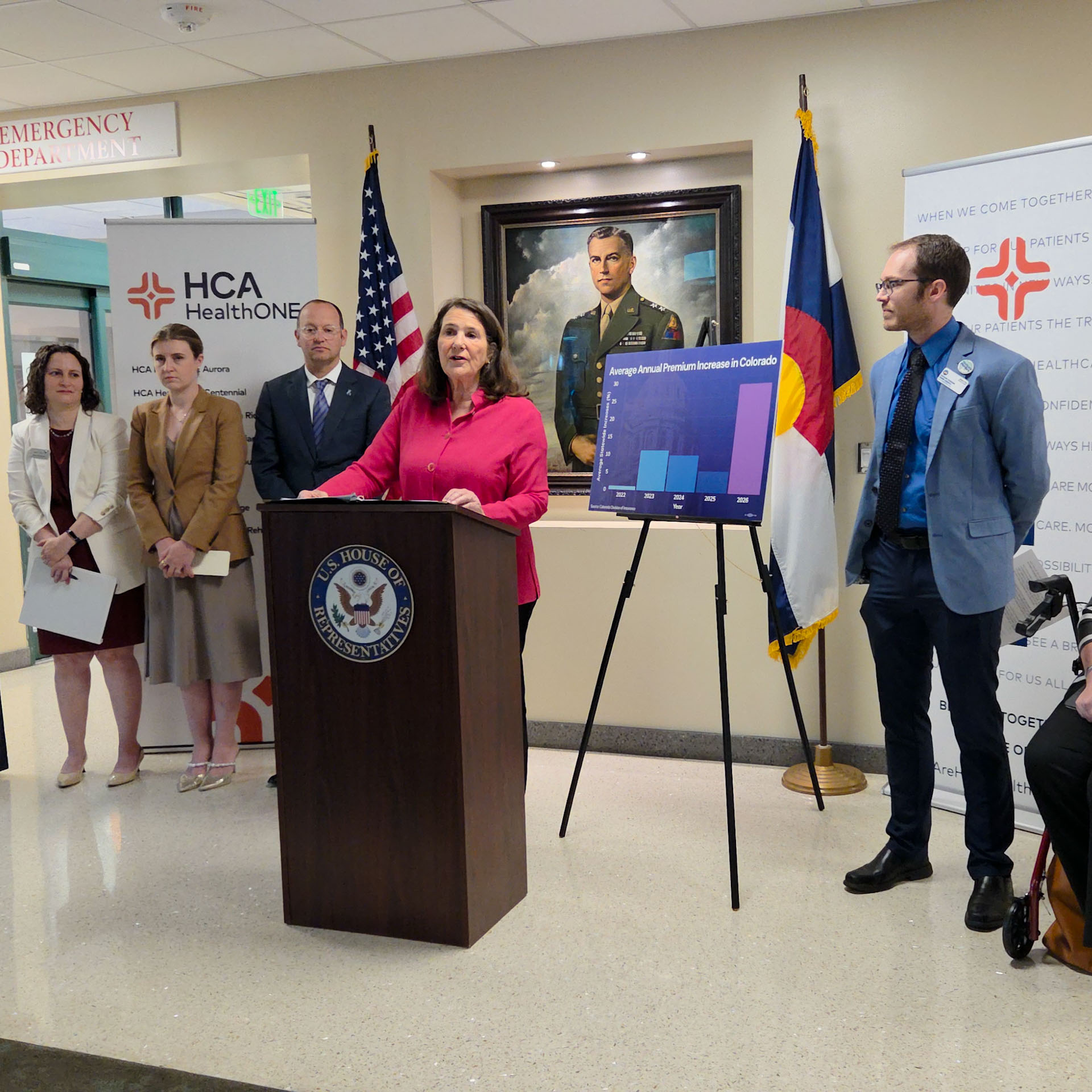 Congresswoman Diana DeGette stands at speaks from podium sided by HCA Healthcare staff and physicians.