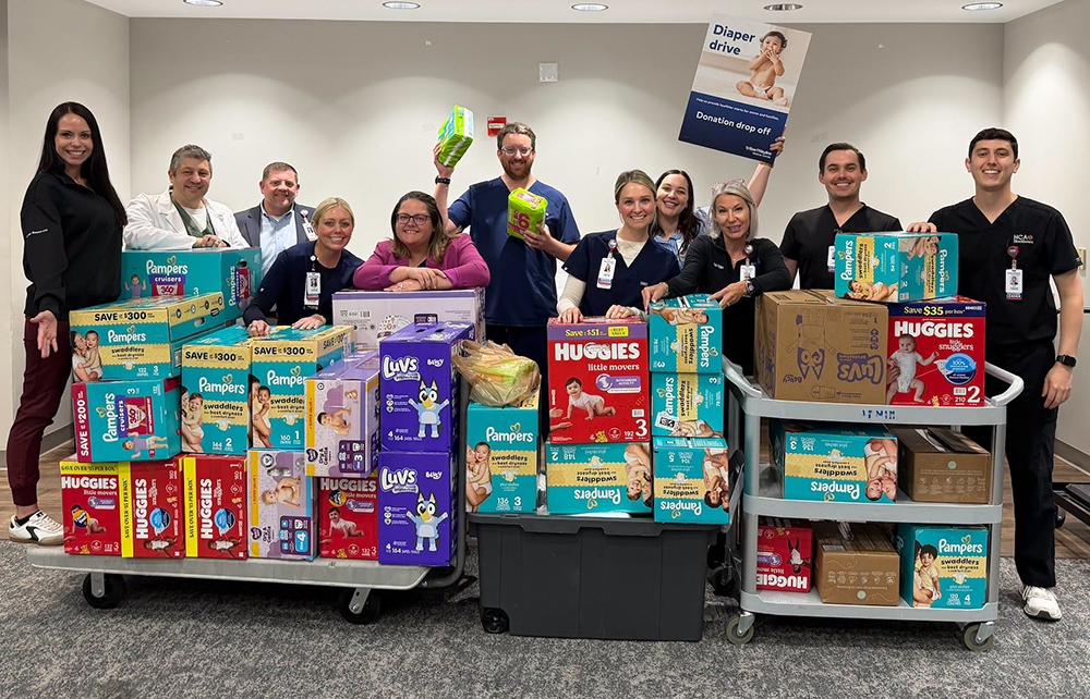 HCA Team members pose with diaper donations.