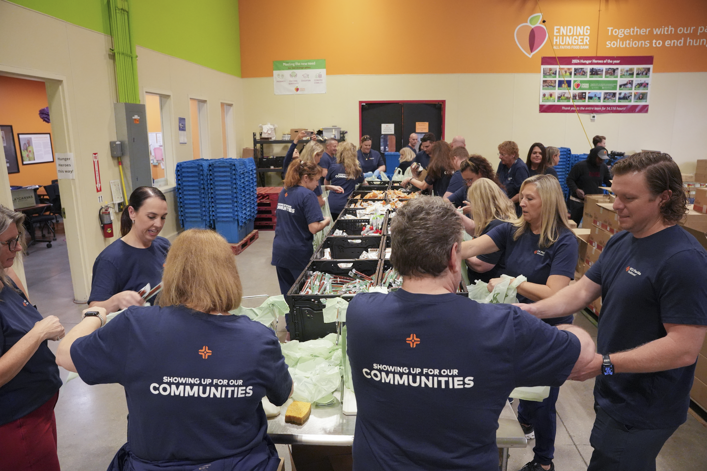 Photo showing of group of hospital leaders packing food.