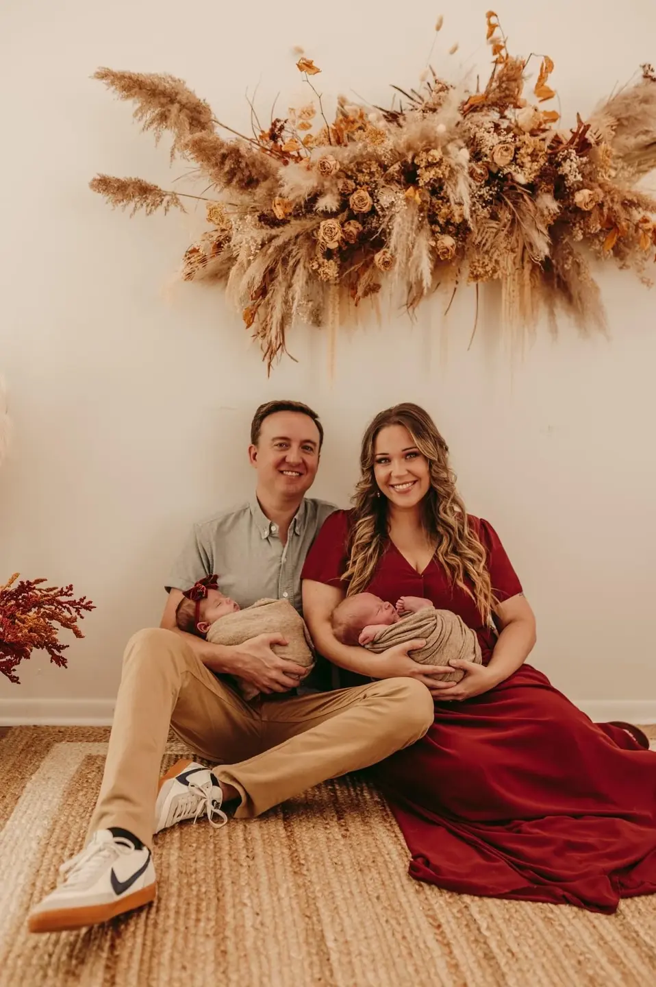 Stephanie Wasson and husband holding newborn twins while sitting