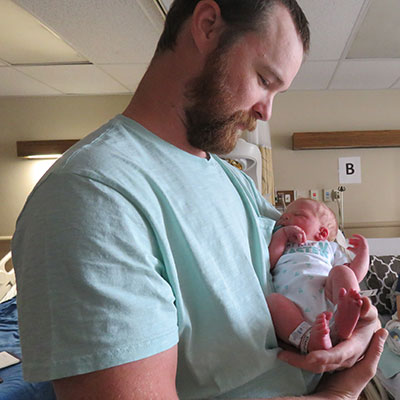Father Daniel holds his newborn boy Nate.