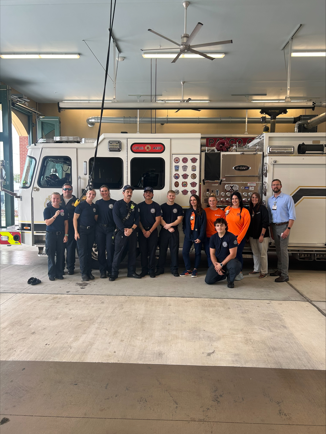 Bayonet Point Hospitla team with Pasco County Fire Rescue team in front of fire truck.