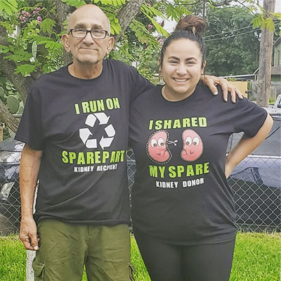 Deanna and her father Richard Navejar standing outside wearing a kidney donor and kidney transplant t-shirts.