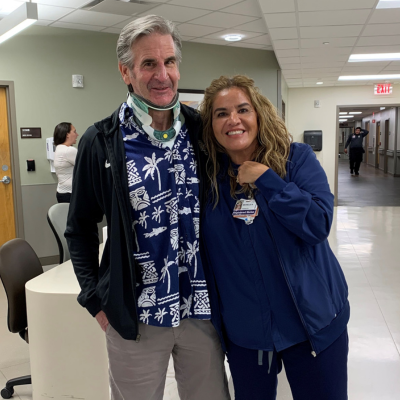 Ken with a nurse while leaving the hospital.