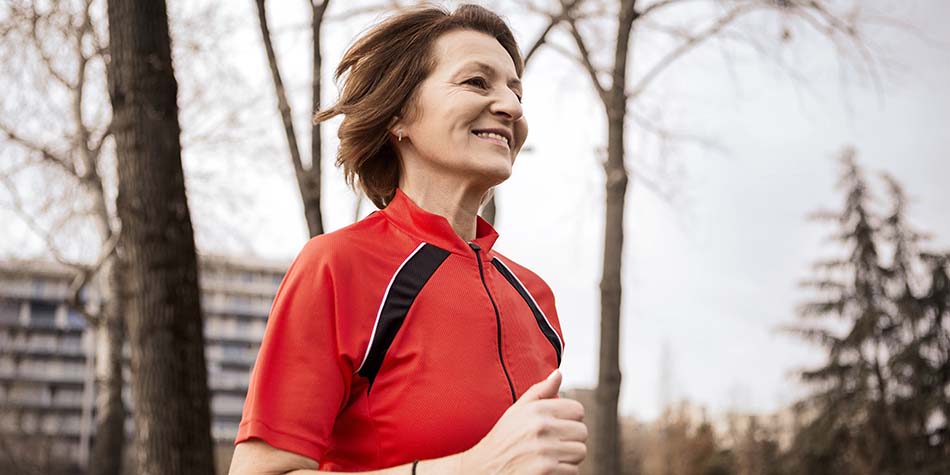 A smiling senior woman runs in the morning