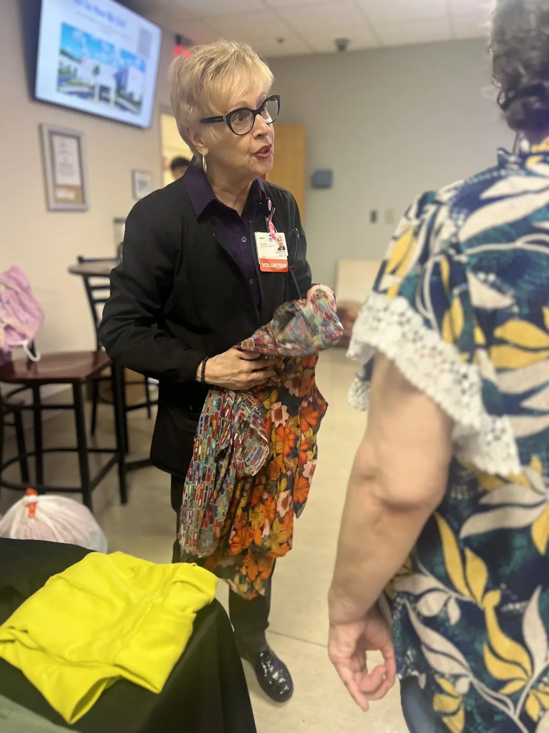 Irene Katrinecz talks to visitors of the sip and swap.
