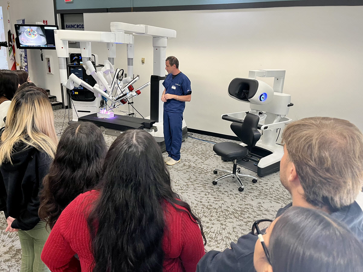 The students learn about one of our surgical robots.