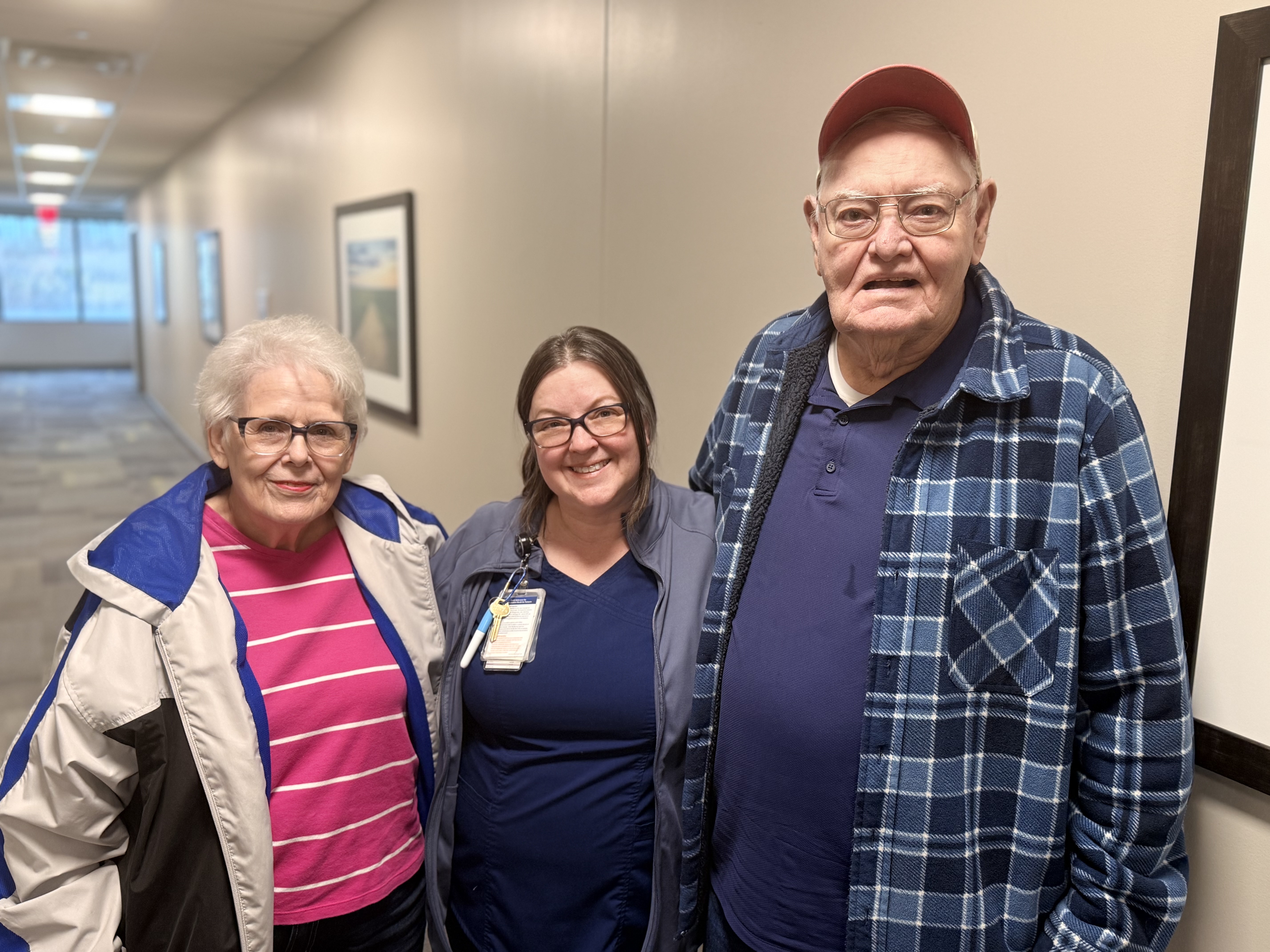 Jack and Linda O'Steen pose for a photo with Kenna, a speech therapist