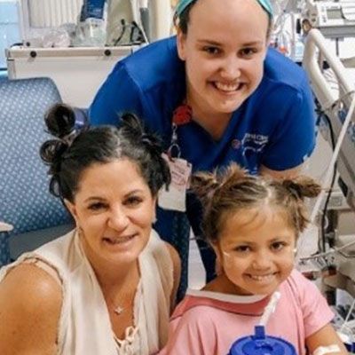 Alaina, with her mother and a nurse.