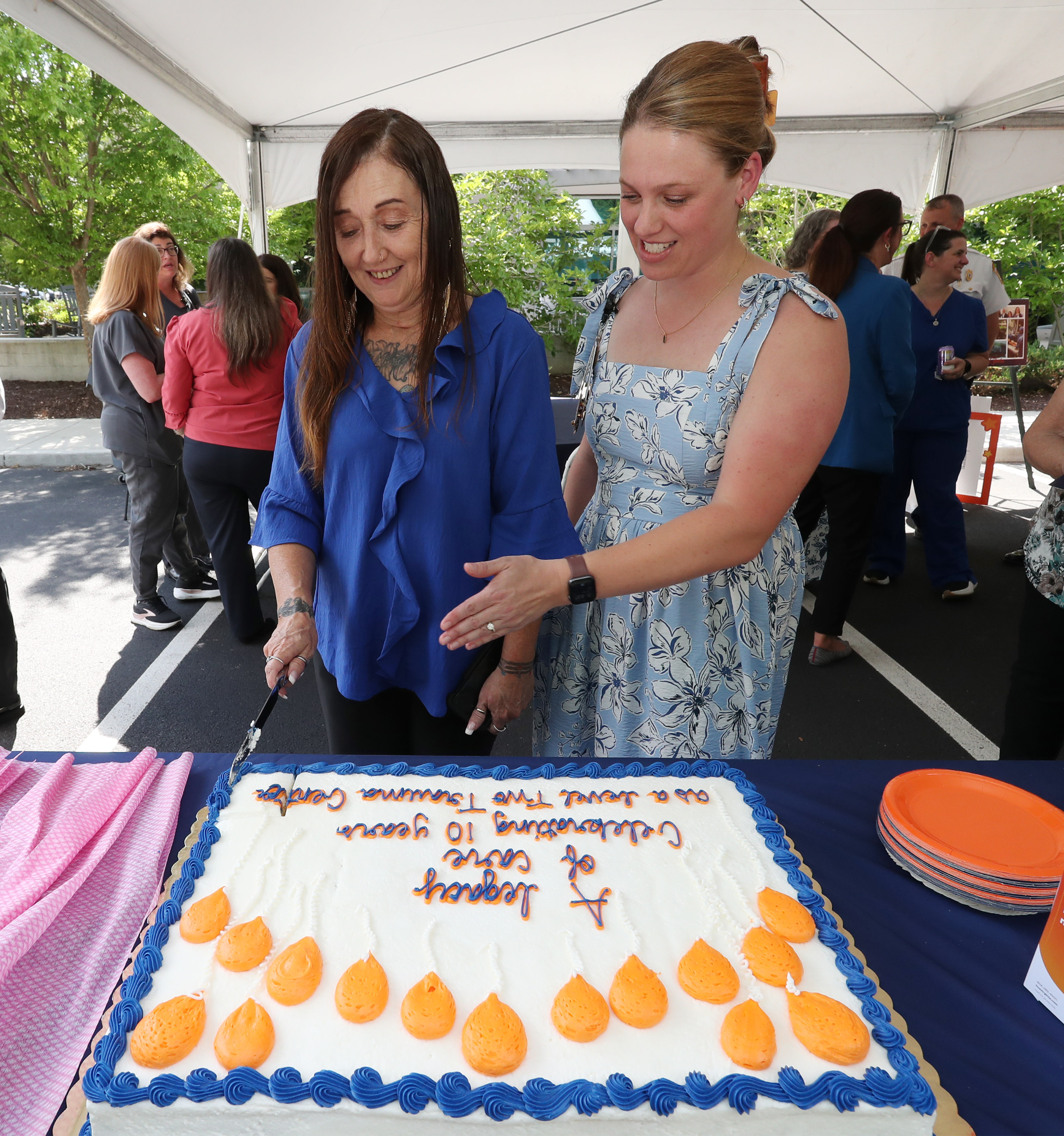 Stacy Burgdorf celebrates with her family, cutting a cake in the process.