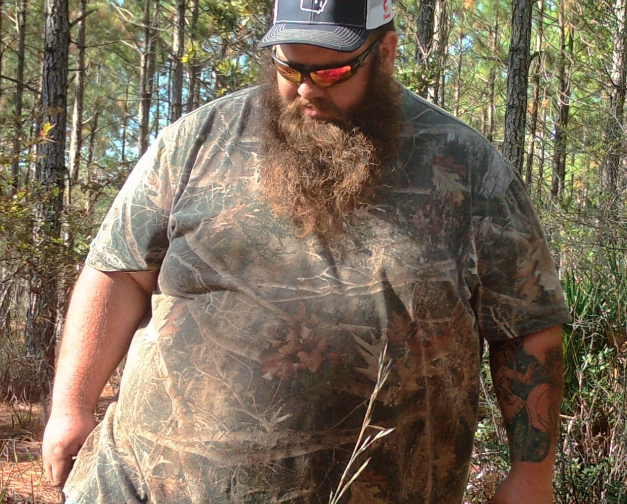 Man stands smiling before his bariatric surgery.