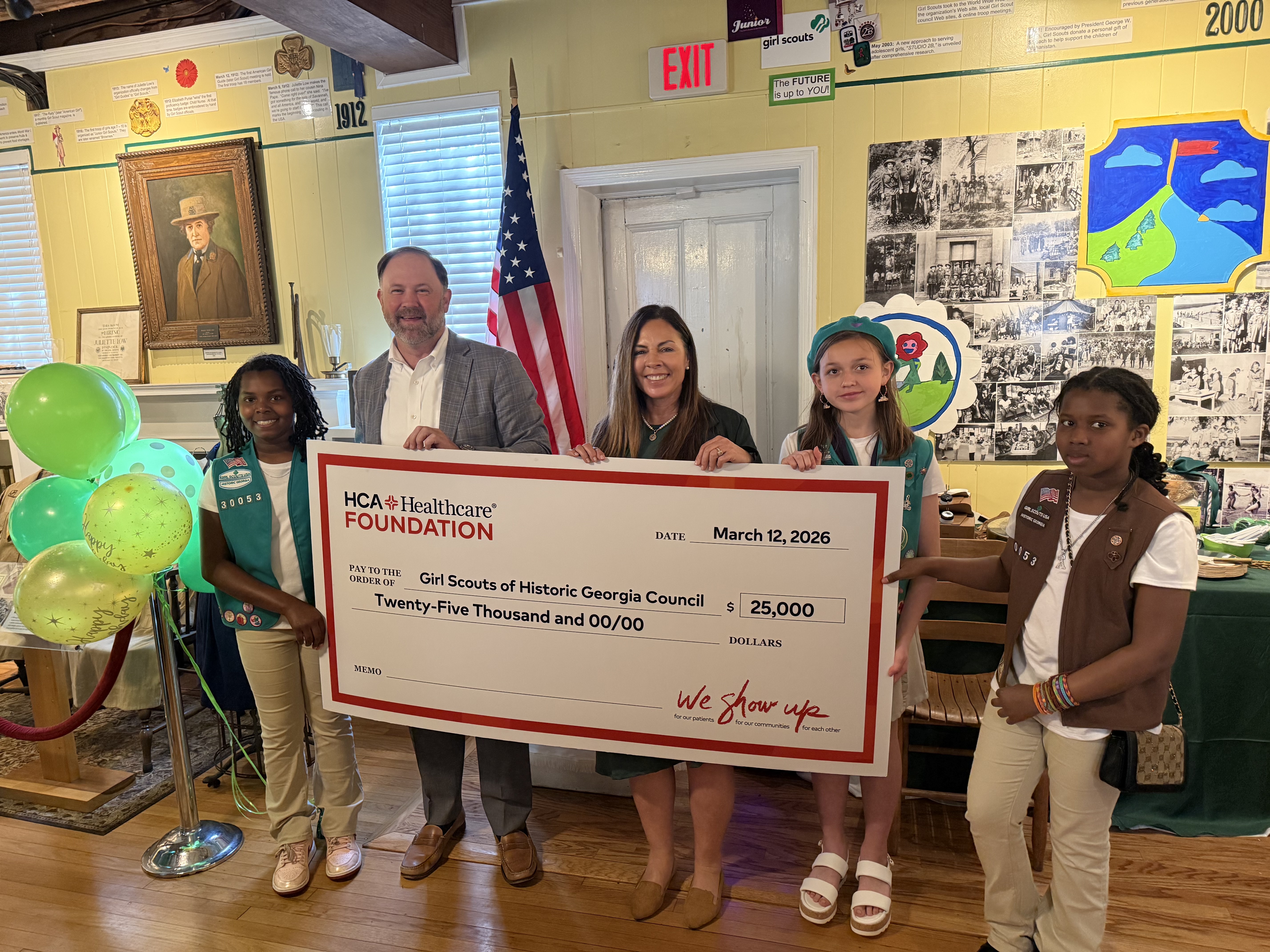 Memorial Health CEO Brad Talbert presents $25,000 check to Girl Scouts leadership and scouts.