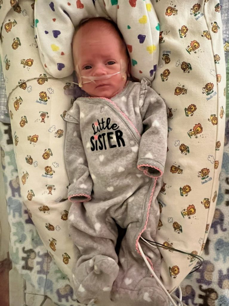 Baby Leilani in her "Little Sister" onsie