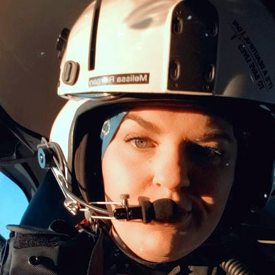 Patient Melissa Reiman wearing a flight helmet and communication equipment.