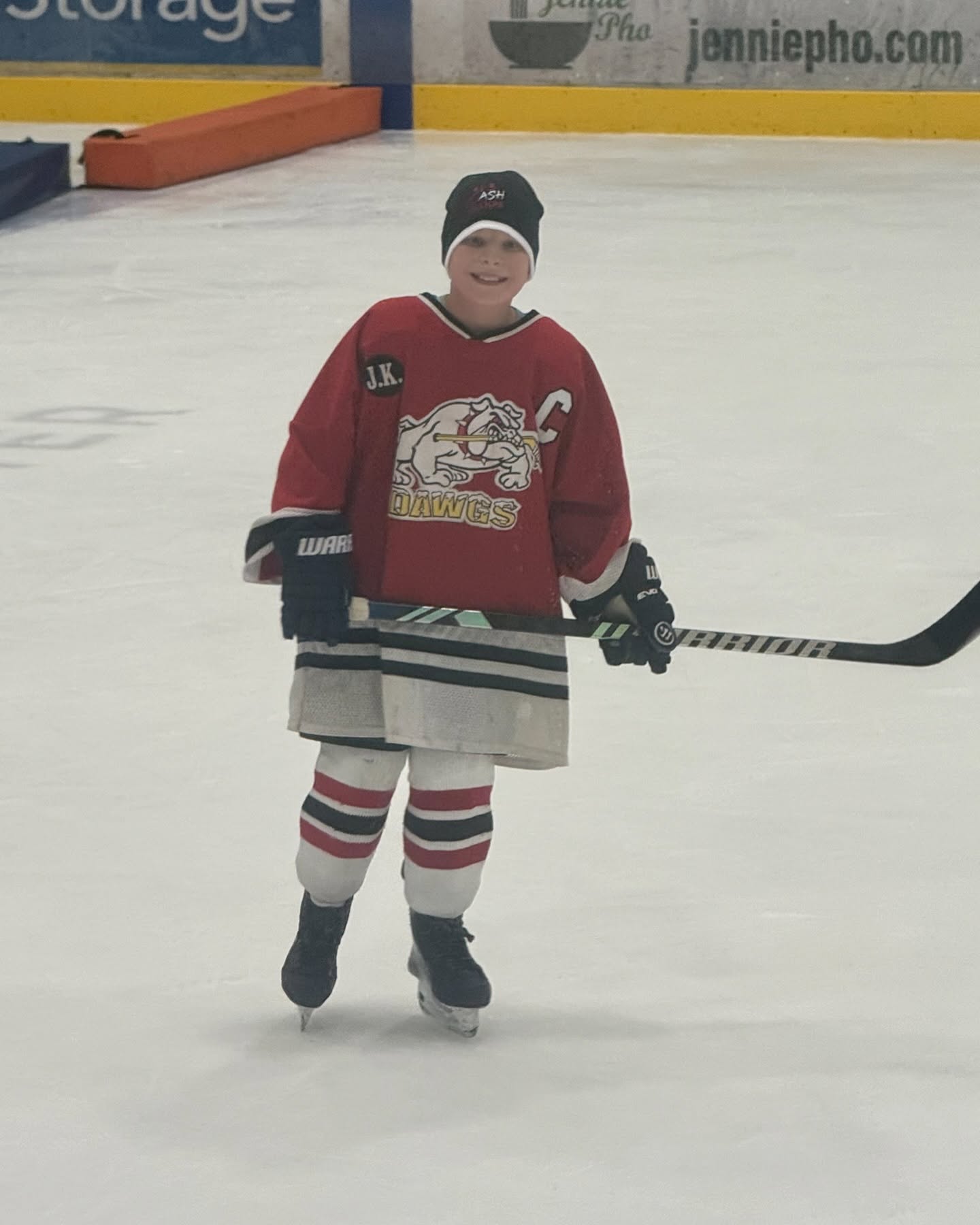 Hunter Murphy skating on an ice rink holding a hockey stick