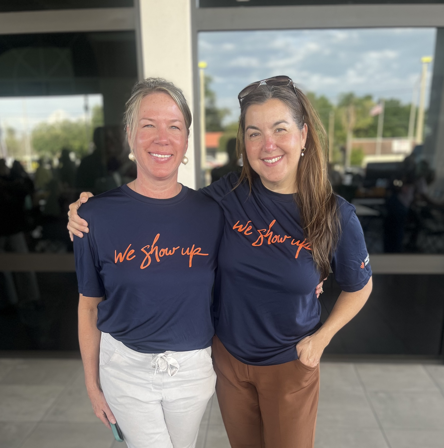Two HCA Florida Blake Hospital colleagues stand together outside the Pace Center for Girls