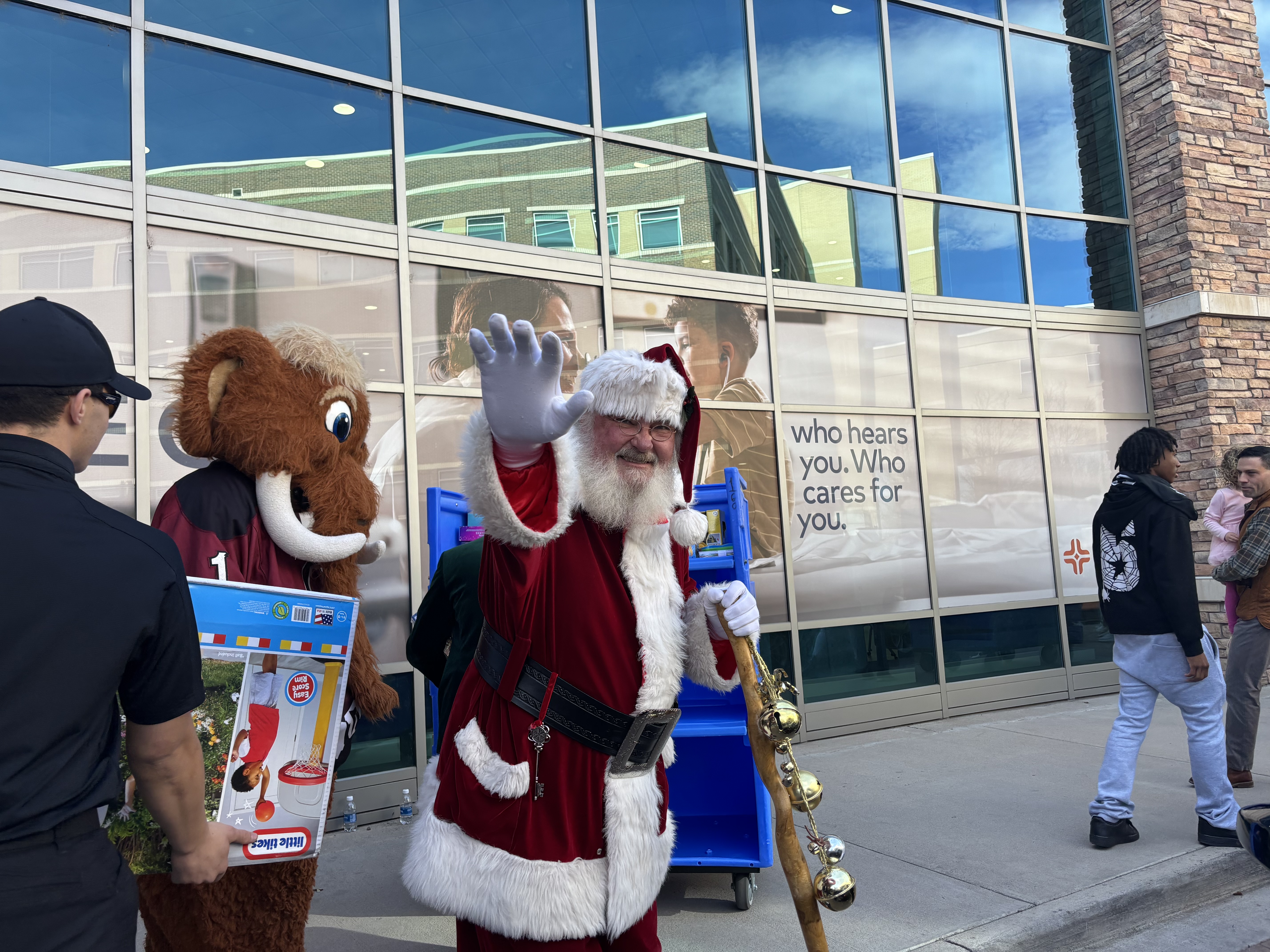 Santa waving at a toy drive.
