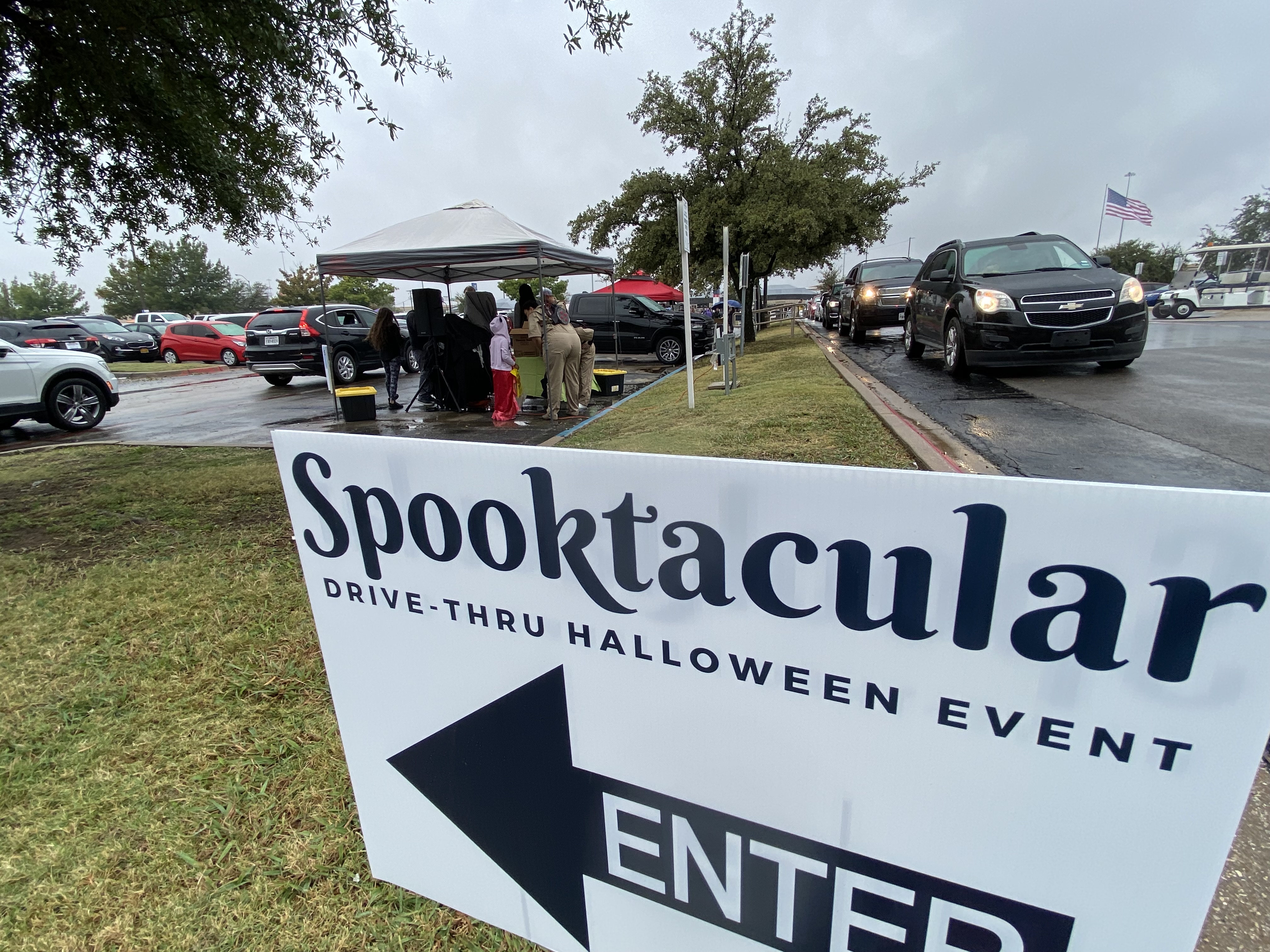 Sign pointing towards Spooktacular Drive-Thru Halloween event.