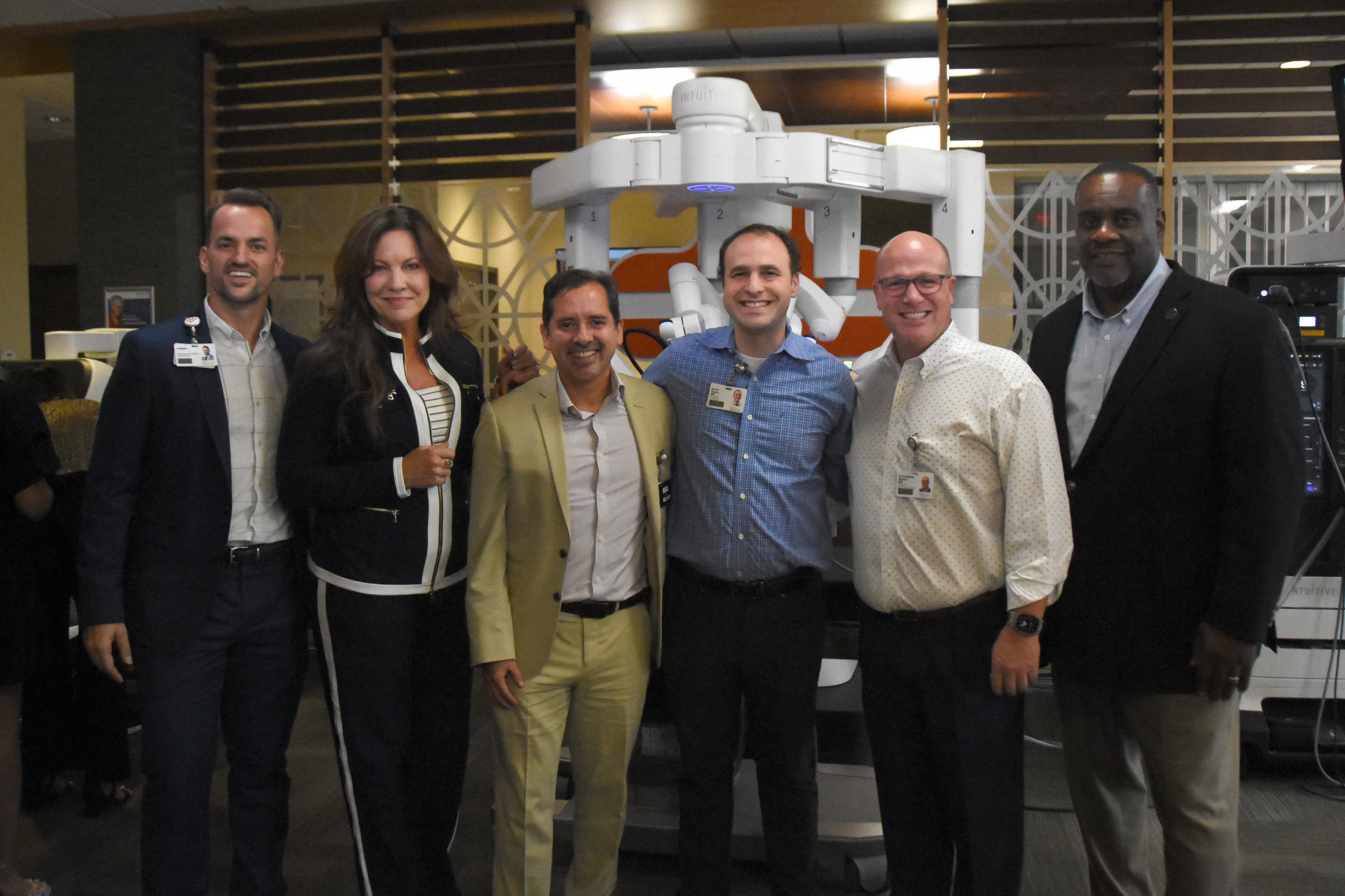 Oviedo Medical Center leaders including Joseph Everette, chief nursing officer; Marcie Cameron, board member; Dr. Harold Neyra; Dr. David Ossin; Dr. Chris Bryant; Jeff Campbell, board member attend hospital open house to unveil new robotic surgery platform. 