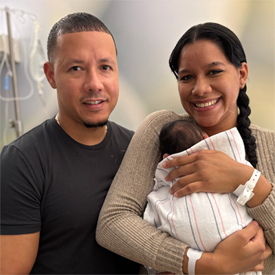 Quelisha and Juan holding their newborn.