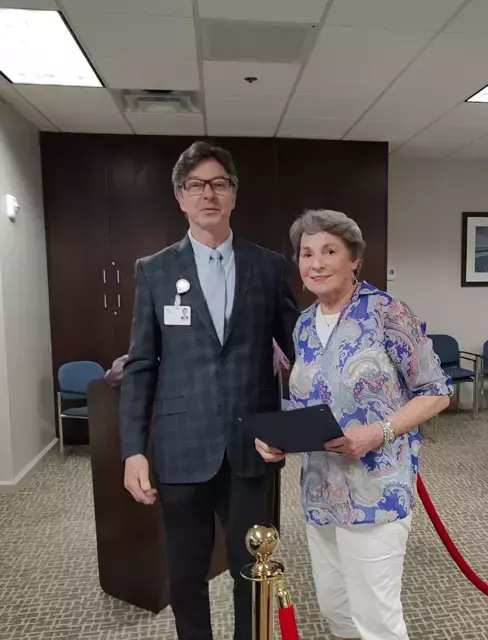 Woman stands with man smiling