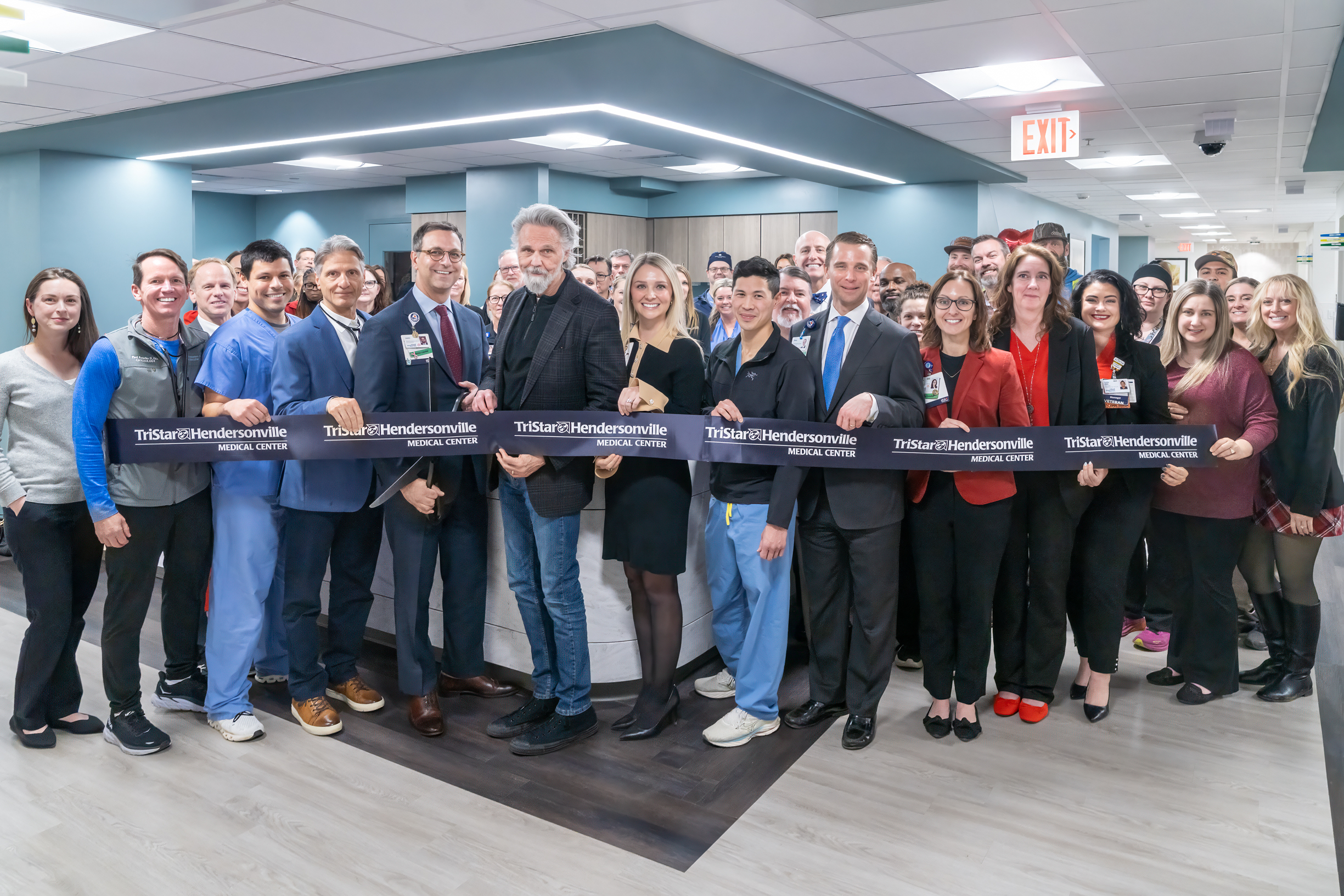 Pictured is those in attendance getting ready to cut the ribbon on the new cardiovascular unit.  