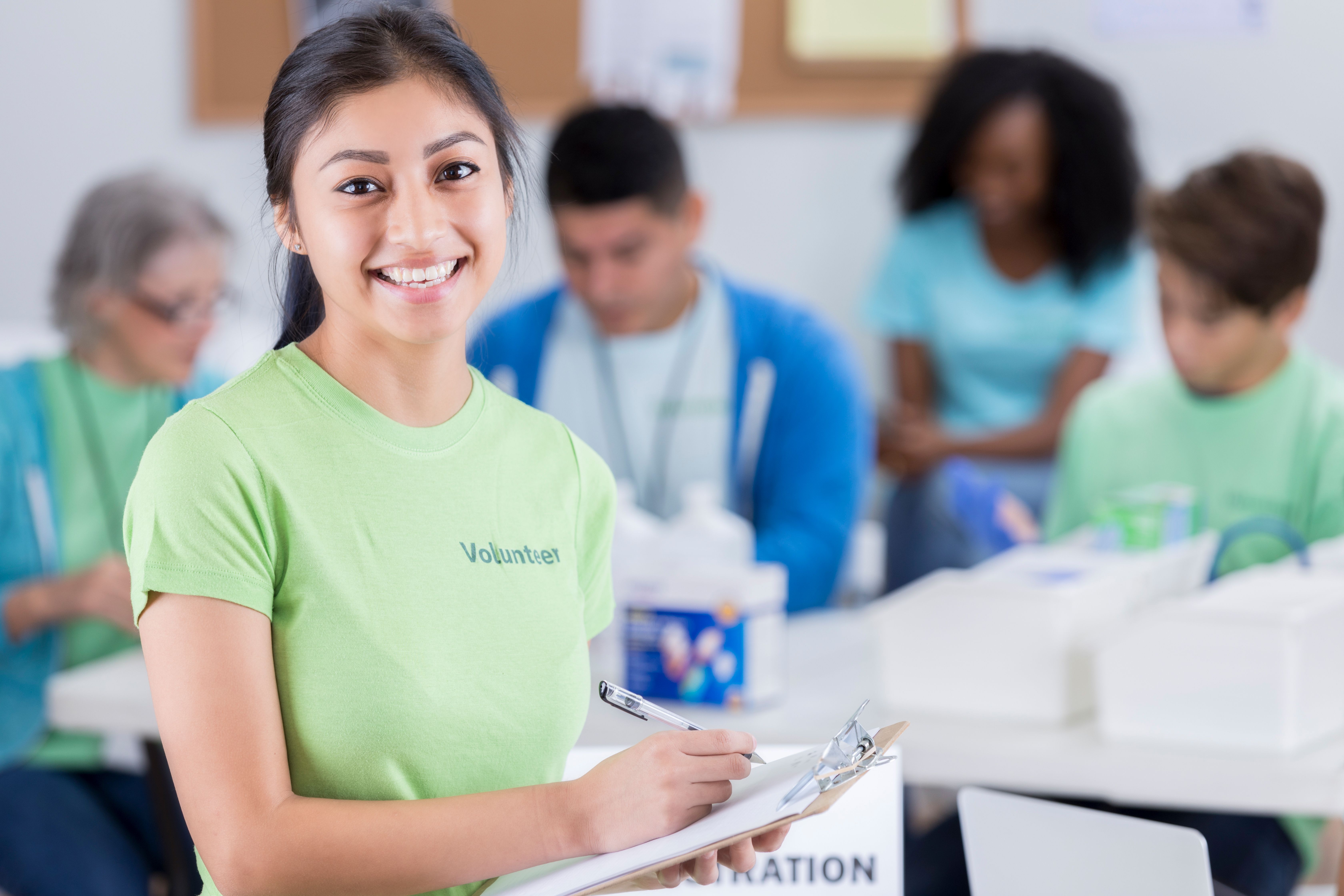 A happy teenager volunteers during community charity event