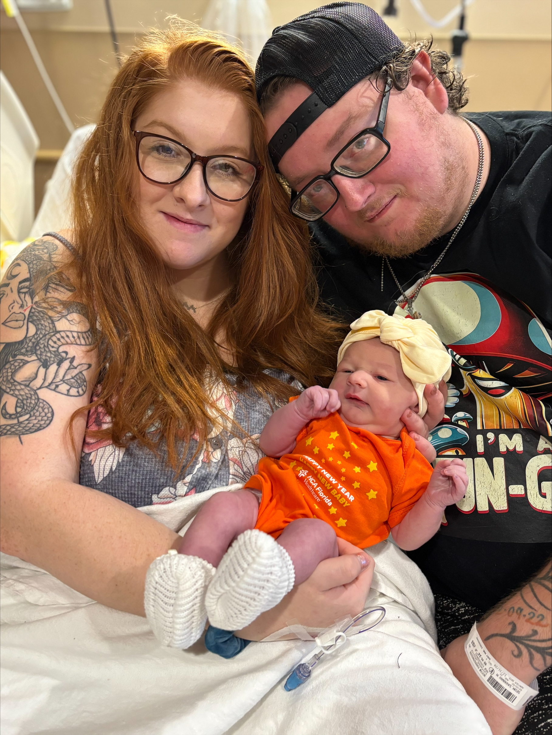 Proud parents holding New Years newborn Amara May Fuller.