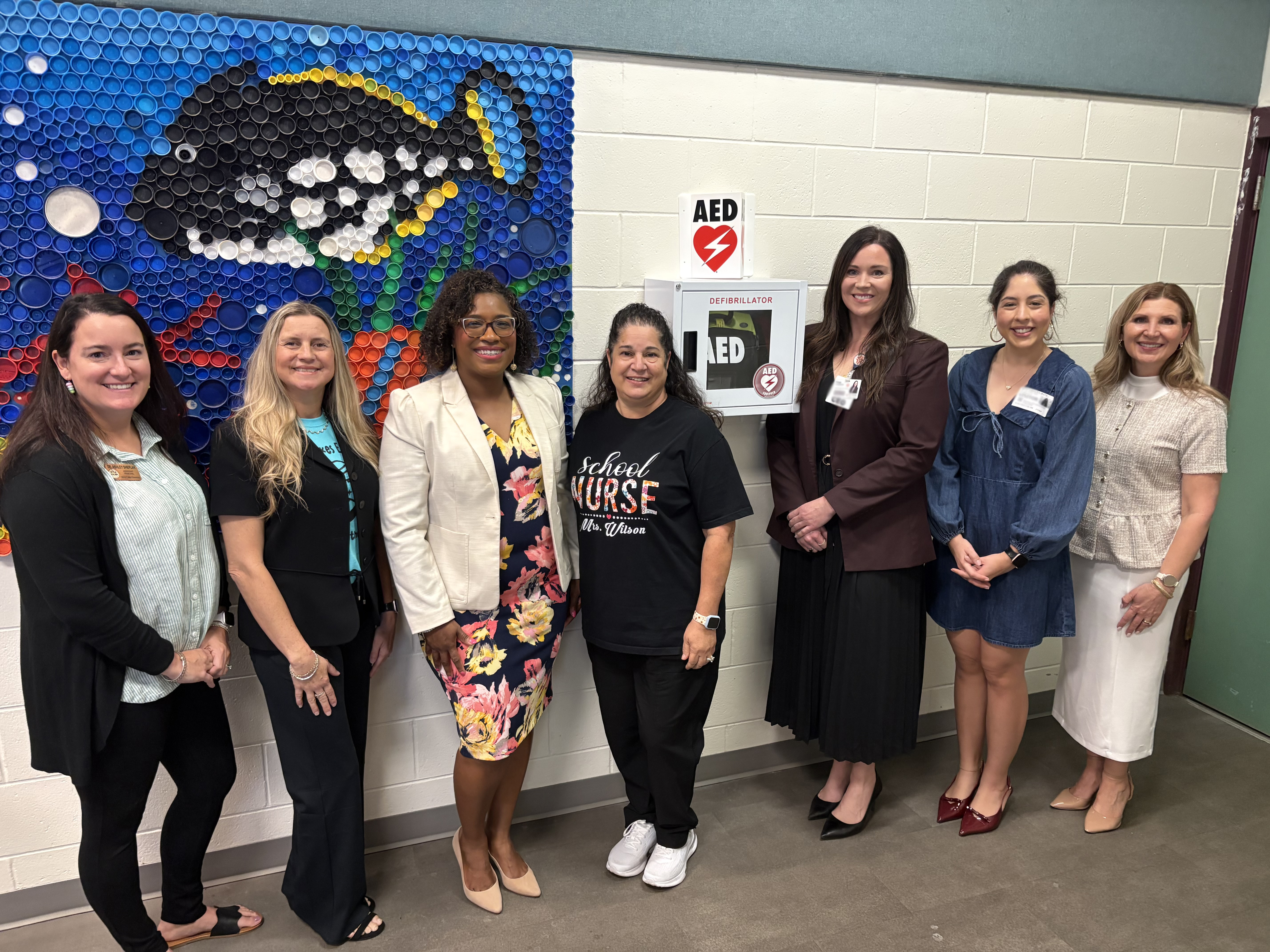 Leaders from Mirror Lakes Elementary School, the American Heart Association and HCA Florida Lehigh Hospital with the new AED donated to Mirror Lakes Elementary.