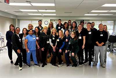 The staff of one of the Far West Division hospitals posing for a photo in the hospital hallway.