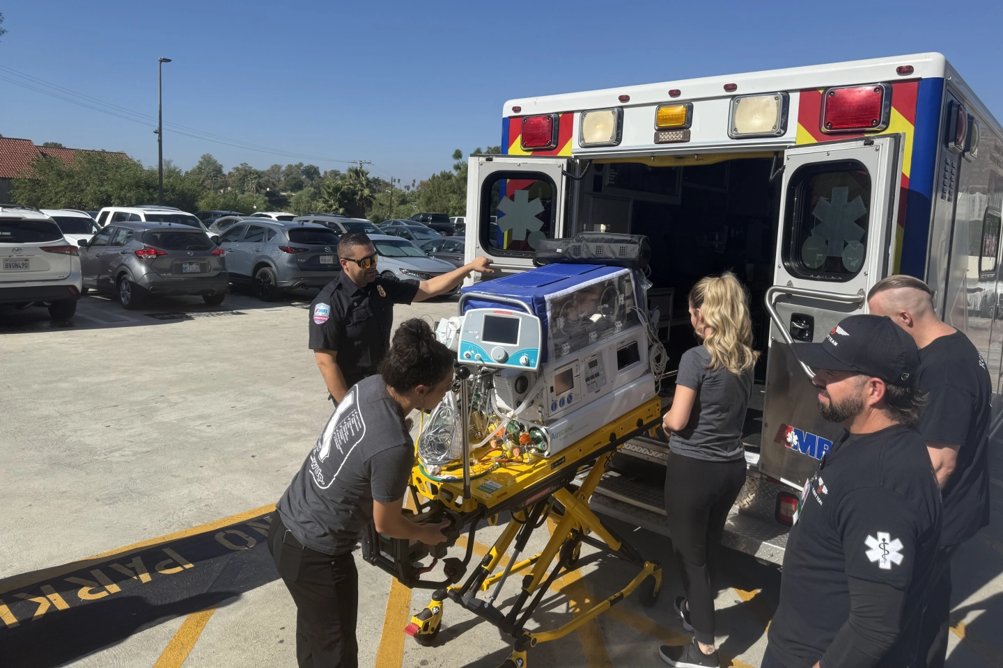 The NICU Transport team unloading the specialized transport patient bed.