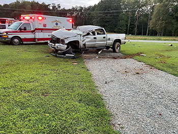 Stephen Yago's wrecked truck next to an ambulance