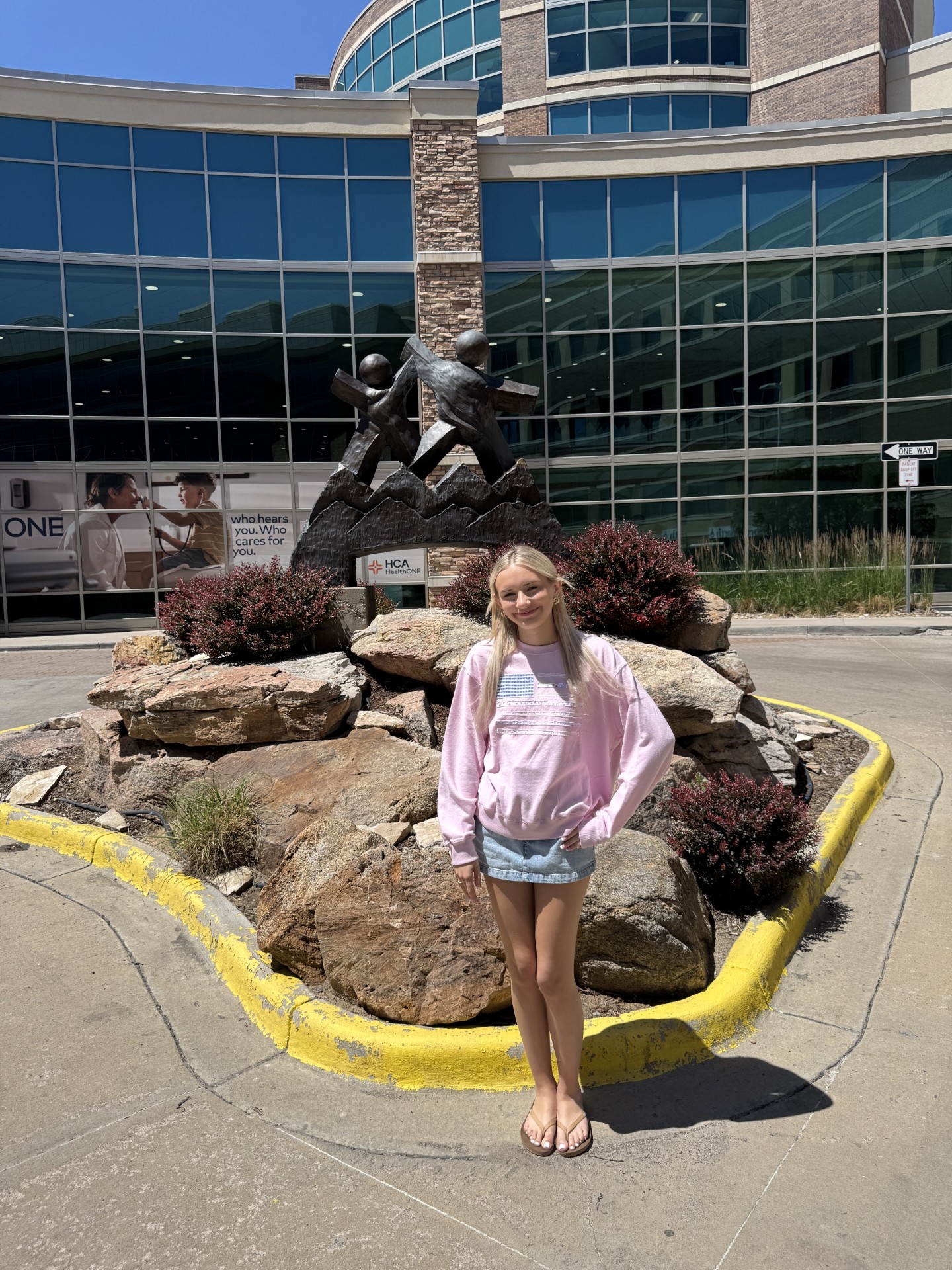 Ava standing in front of statue outside of Rocky Mountain Children's hospital.