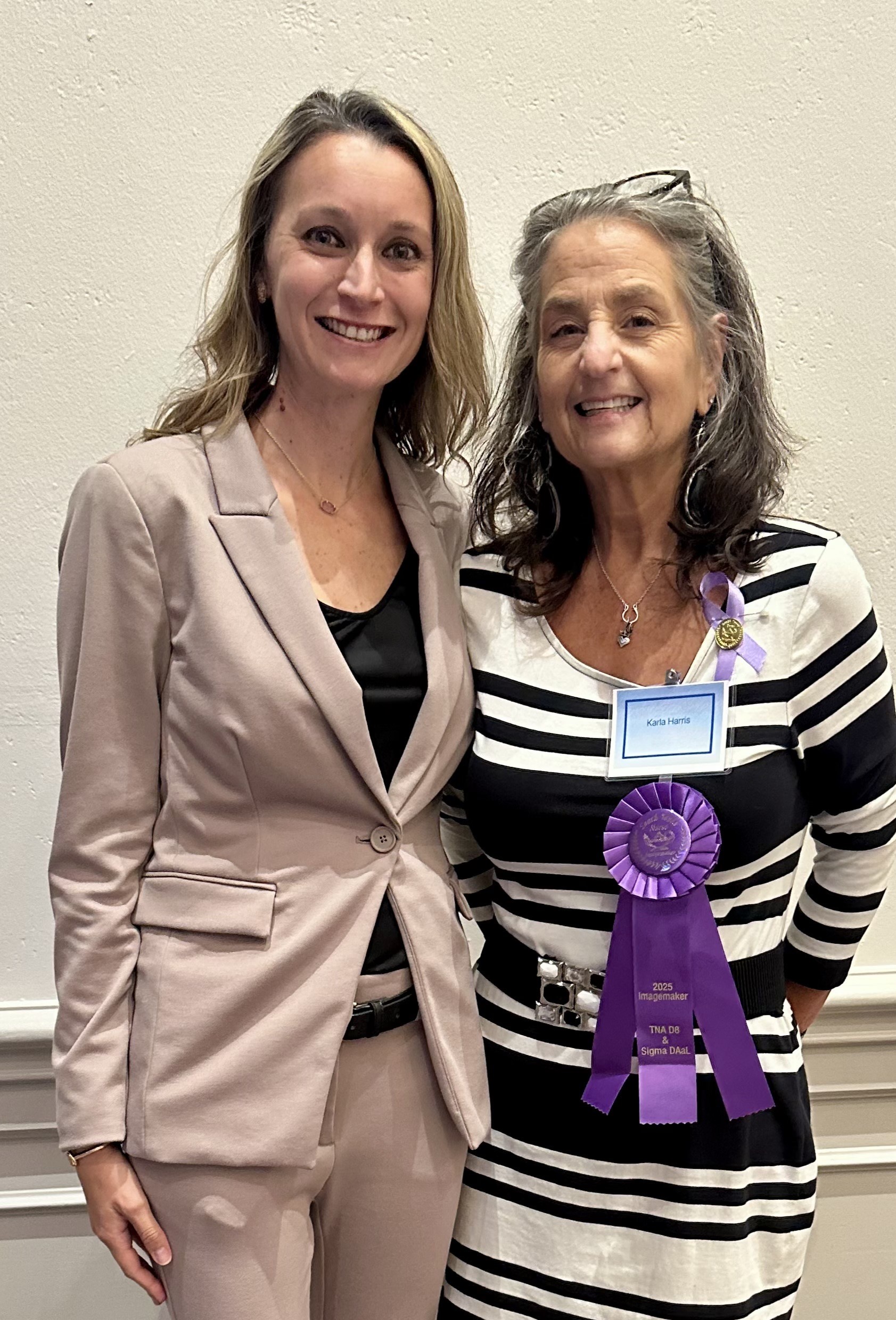 Karla Harris with purple ribbon accepting her "Imagemaker" award.