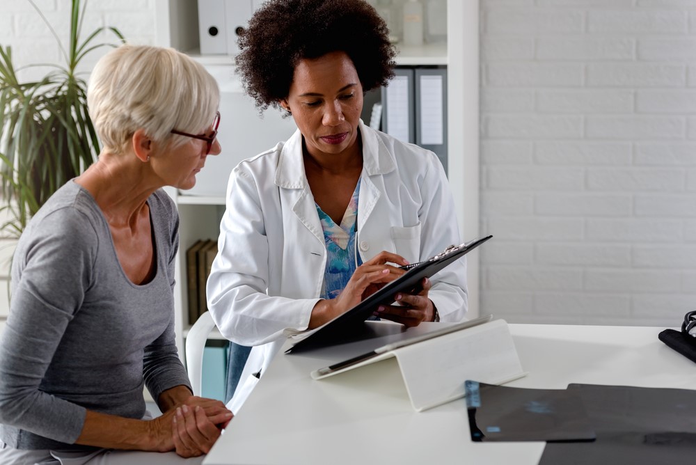 A female doctor consults with a mature woman