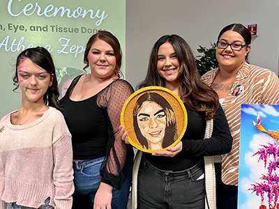 Female friends and family of organ, eye and tissue donor Athena Zepeda hold a Floragraph of her face that will be featured on a memorial float in the famous Rose Parade. 