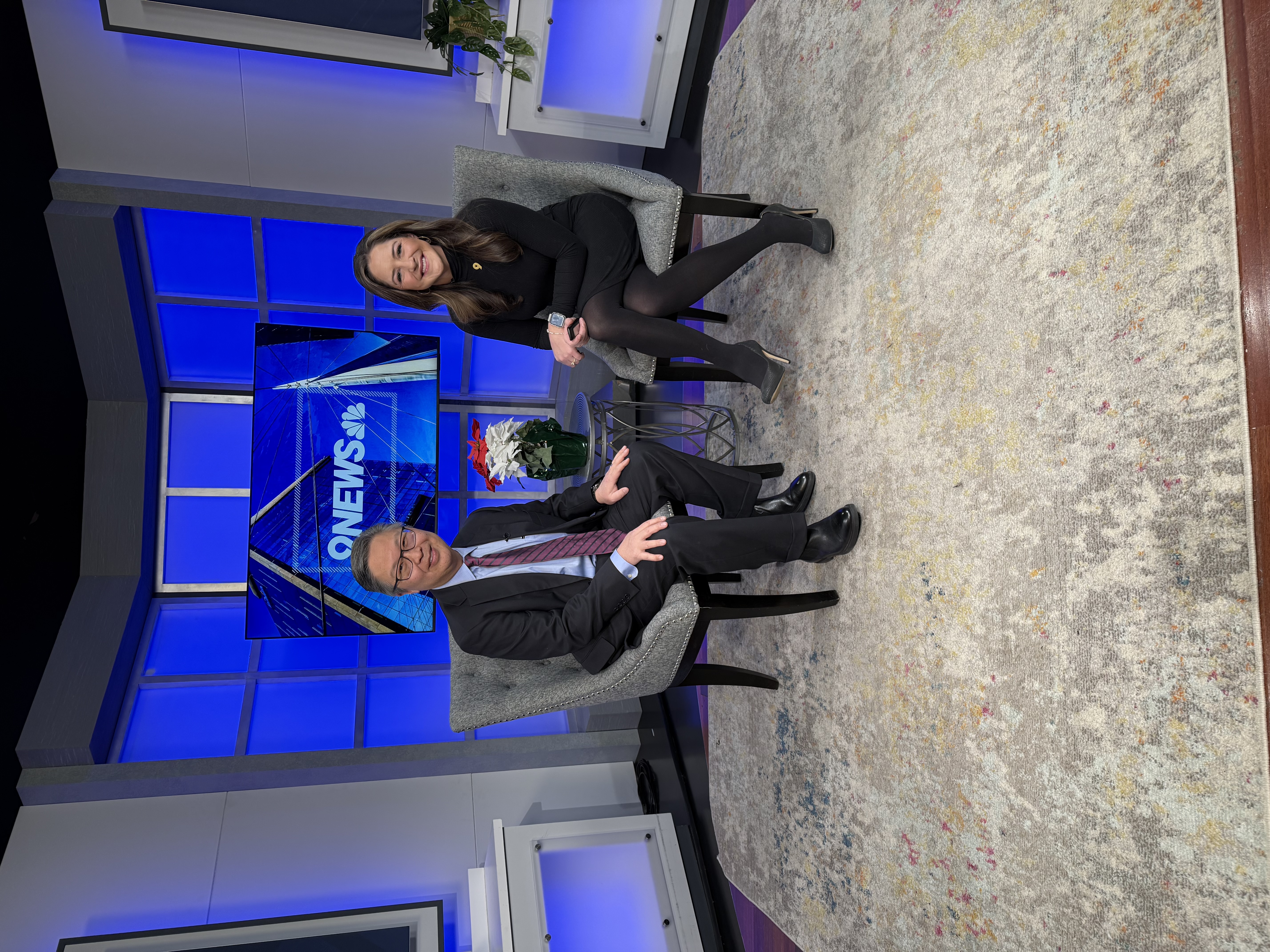 Two news anchors on set.