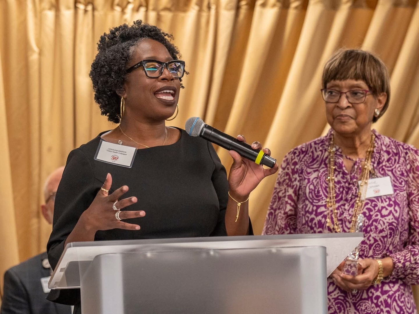 (l-r) Leshauna Barron, was the third baby born at Trident Medical Center and has worked at the hospital for 15 years. She was joined in the platform by Bonnie Johnson, who started worked at Trident a month before it officially opened and still works at Trident Health.