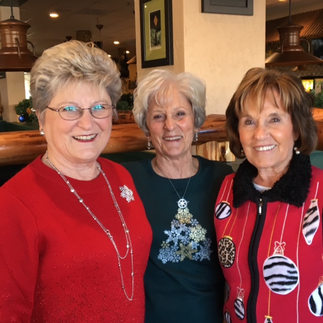 Betty Golden and her two sisters smiling.