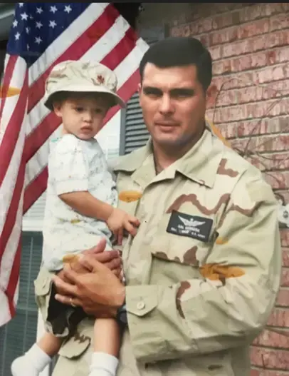 Colonel Herrara holding his child.